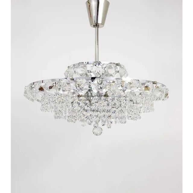 A beautiful and elegant chrome-plated crystal chandelier by Bakalowits Vienna from the 1950s. It has five tiers, fully...