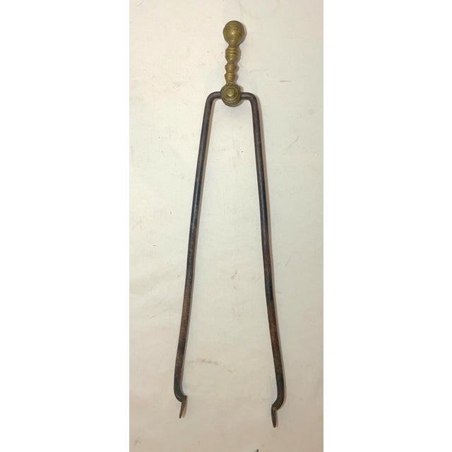 Up for sale is a nice pair of rare antique 18th century wrought iron and brass English fireplace tongs. The arms are...