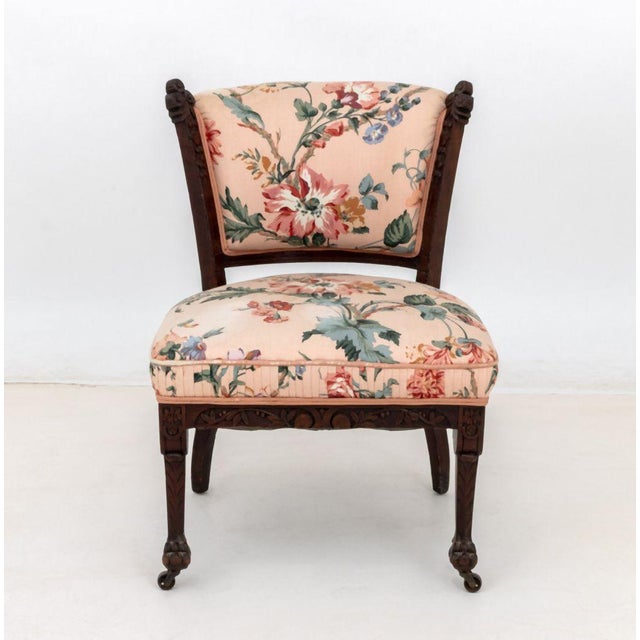 Renaissance Revival Floral Upholstered Low Chair, on carved front paw feet with casters. 30.75" H x 22" W x 23" D; seat:...