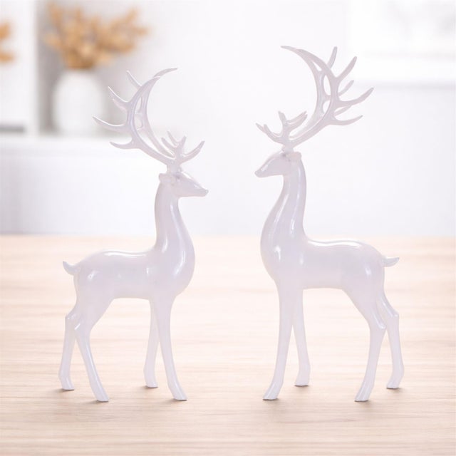 Bring graceful winter elegance to your home with this White Standing Deer Figurine Set. Featuring two sleek stag designs...
