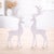 Bring graceful winter elegance to your home with this White Standing Deer Figurine Set. Featuring two sleek stag designs...