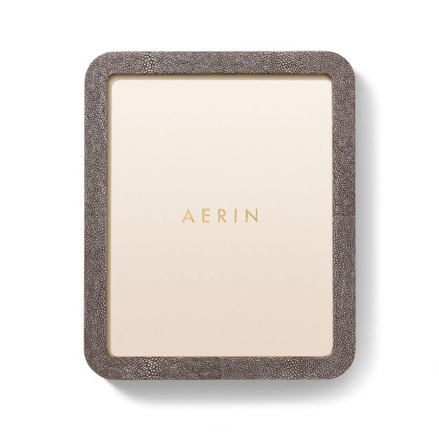 This contemporary frame is finished with textured, embossed Faux Shagreen and is styled with curved lines. The minimalist...