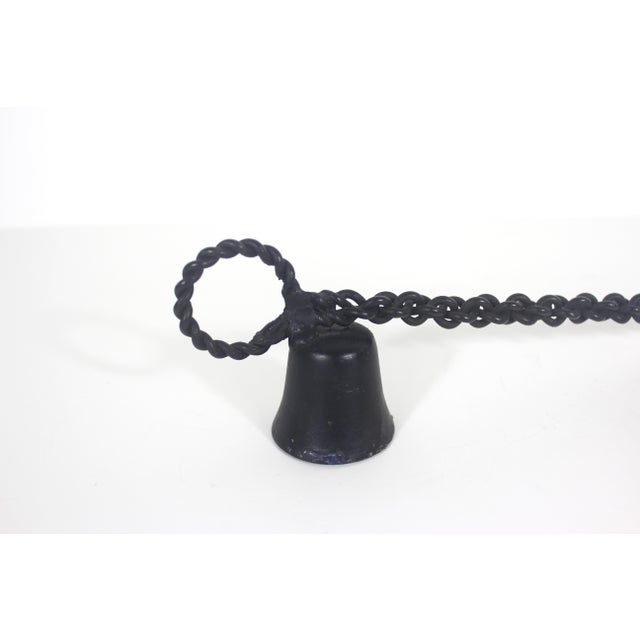 Black metal candle snuffer with a twisted chain handle and loop. Perfect for farmhouse or romantic decor. Some soot and...