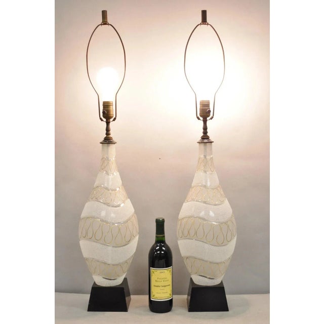 Vintage Mid Century Modern Sculpted Frosted Glass Gold Wavy Design Table Lamps on Black Painted Metal Bases - a Pair....