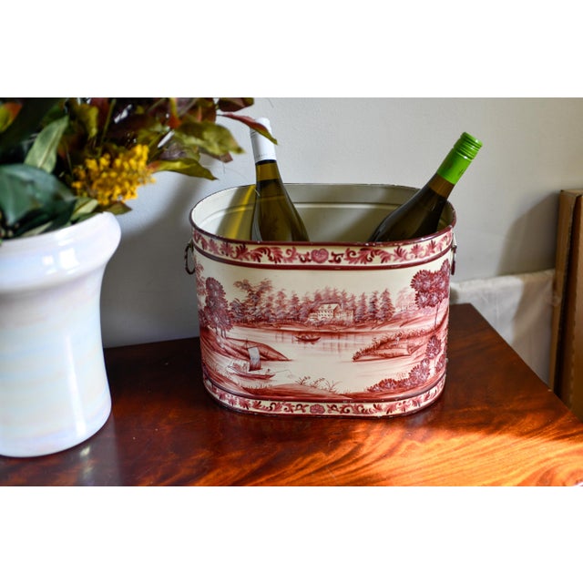 Vintage oval toleware planter with hand-painted sepia-burgundy pastoral scene: a lakeside house, sailboat, rowboat, and...