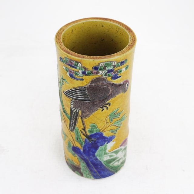 A stunning antique Chinese porcelain hat stand porcelain vase featuring a vibrant yellow glaze and an intricate hand-...