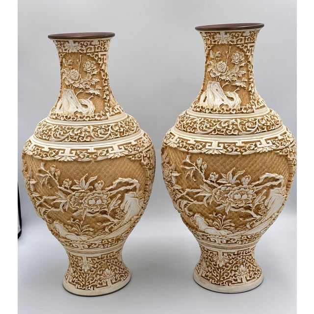 A pair of beautifully carved vintage Chinese cinnabar lacquer vases featuring intricate floral and foliate reliefs...