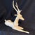 Elegant seated dear. Cast resin material which feels like wood- with an antique white patina. 19” long x 16” tall x 5” wide