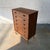 A tall Danish teak chest from the 1960s, with a narrow vertical profile and six graduated drawers that make it especially...