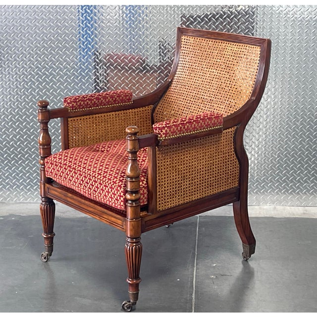 An elegant English Regency–inspired armchair featuring a solid wood frame with a rich, warm finish. The chair showcases...