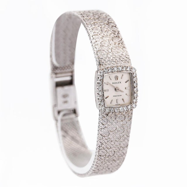 18K white gold Rolex Precision Swiss made watch features an elegant, square dial encircled by a diamond bezel, enhancing...