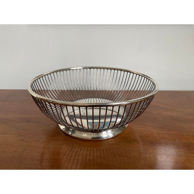 Add a touch of timeless English-inspired elegance to your table with this vintage silverplated bread basket. This piece...