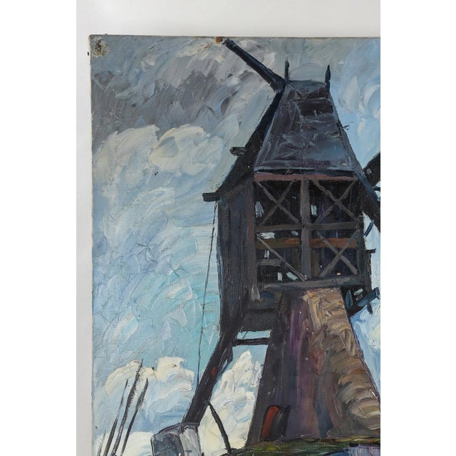 The prominent feature in this painting is the windmill atop a hill, towering over a town with a train tunnel or mine shaft...