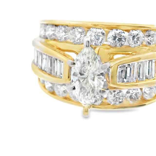 This beautiful 14k yellow gold engagement ring features over 2 carats of natural diamonds! The center stone is a 0.57...