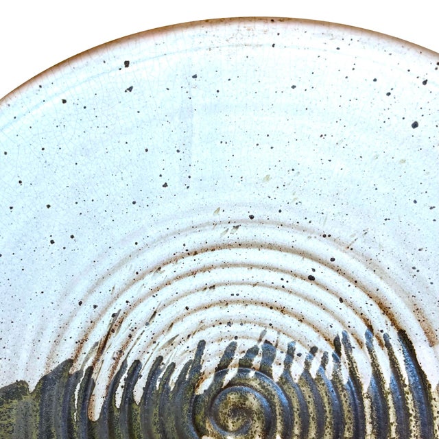 Substantially large 1980's stoneware pottery charger. - 21" diameter. Hand thrown on a potters wheel - its ridged front is...