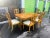 This elegant vintage dining set features a beautifully crafted wood dining table paired with six matching chairs. The...