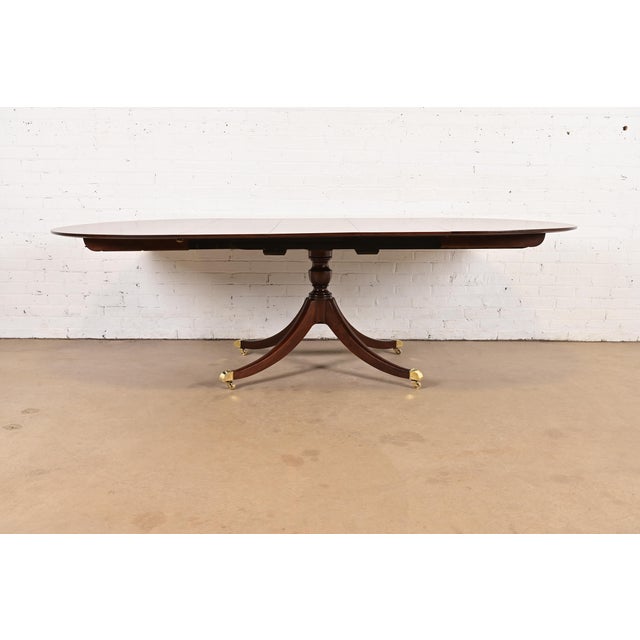 An exceptional Georgian or Regency style pedestal extension dining table By Baker Furniture USA, Circa 1960s Beautiful...