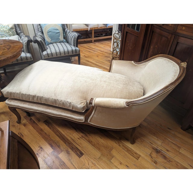 Vintage French Chaise Lounge with a hand carved solid hardwood frame. Gold accent on the top carving. New upholstery and...