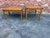 Pair of campaign-style accent tables from the Drexel Accolade Collection Featuring golden wood finish and distinctive...