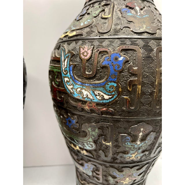 Japanese, 19th century. This exquisite pair of 19th-century Japanese Champlevé or cloisonne style inset bronze vases...