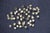Large dimensional metal wall sculpture featuring an organic arrangement of hammered brass leaves and small dark metal...