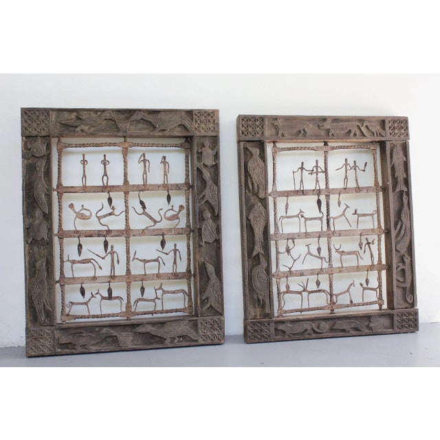 A very unique complimentary set of 2 Indonesian architectural art 'window' panels with dark wood frame with carvings of...