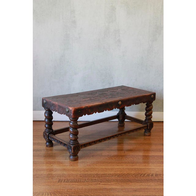 This beautifully hand-tooled Peruvian piece adds charm and can serve as either a bench or a coffee table. It has wooden...