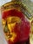 Carved wood Buddha head, early 20th century, with red lacquer showing through gold leaf that handling has worn thin, and a...