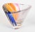 A Swedish Crystal Movement bowl or vase crafted by Kosta Boda. The bowl is made of clear glass with vertical, polychrome...