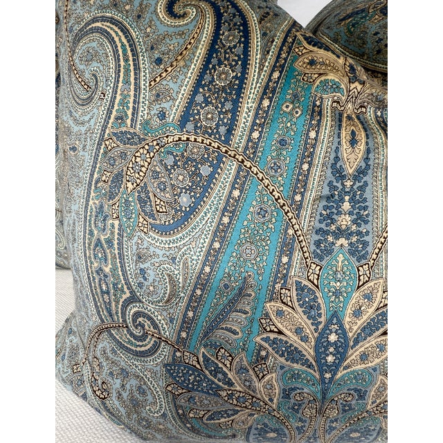 Custom pair of 22" pillows covered in a paisley velvet fabric in light and dark blue and deep aqua. These pillows have...