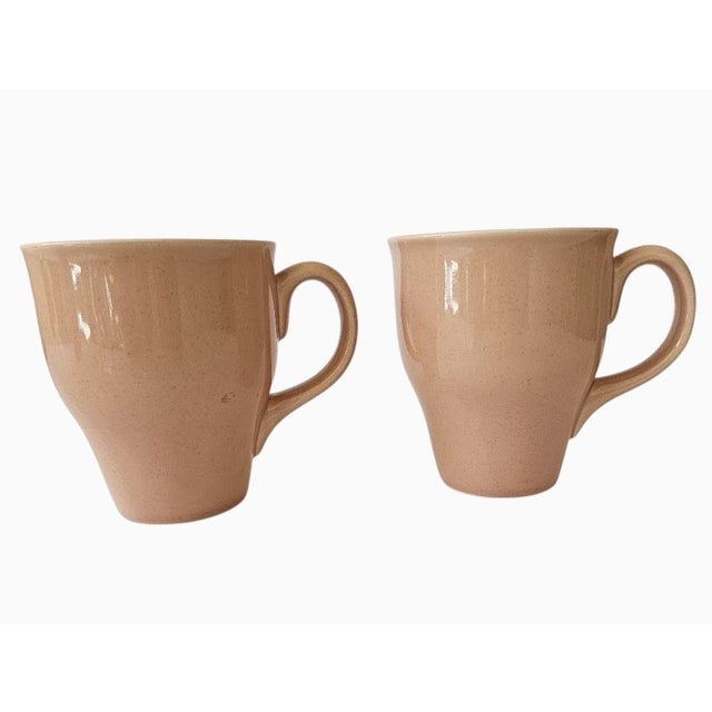 Set of two Russel Wright Oneida MCM style stoneware tall coral pink coffee mugs. Each mug holds 1-3/4 cups (14 ounces) and...