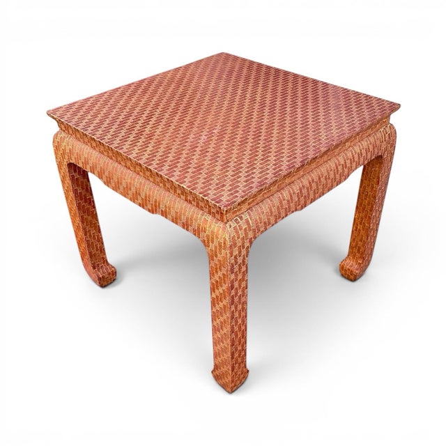 A lovely Ming-style cocktail table by Baker made of textured raffia fully wrapped over wood. A matching console table is...