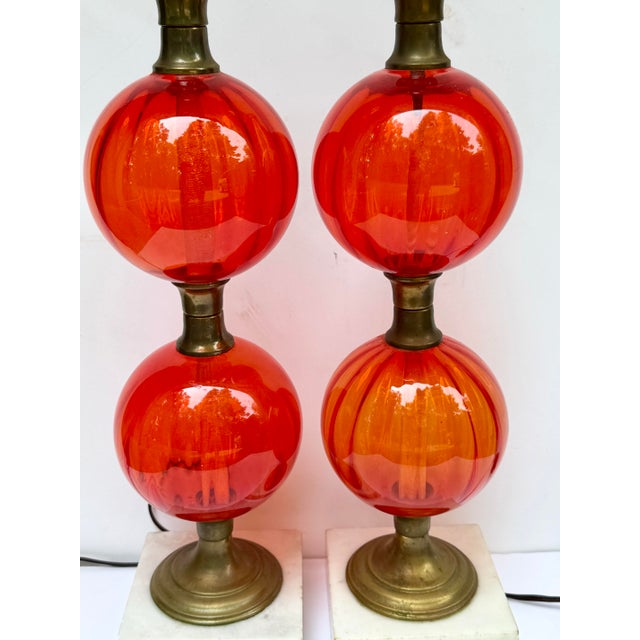 If your're a lover of vintage lighting - you'll love these. Handblown glass spheres in a vibrant orange color with brass...
