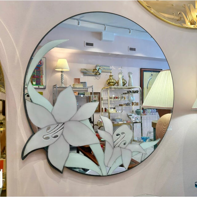 Striking circular mirror with large flower appliqué details by David Marshall. Circa 1980's.