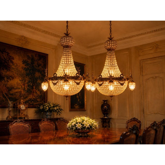 A grand pair of vintage late 20th-century French Louis XVI–style deer chandeliers, crafted in gilt bronze with a rich gold...