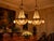 A grand pair of vintage late 20th-century French Louis XVI–style deer chandeliers, crafted in gilt bronze with a rich gold...