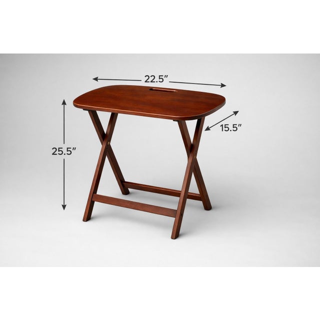A pair of mid-century folding snack tables featuring sculpted wood tops with integrated carry handles. These compact...