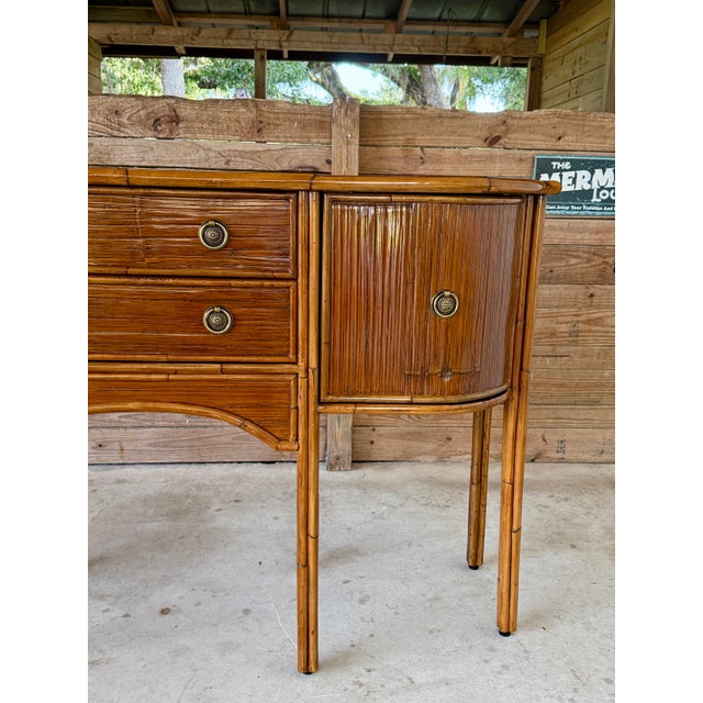 A beautifully handcrafted rattan sideboard by E. Murio of Manila, dating to the late 20th century and newly refinished to...
