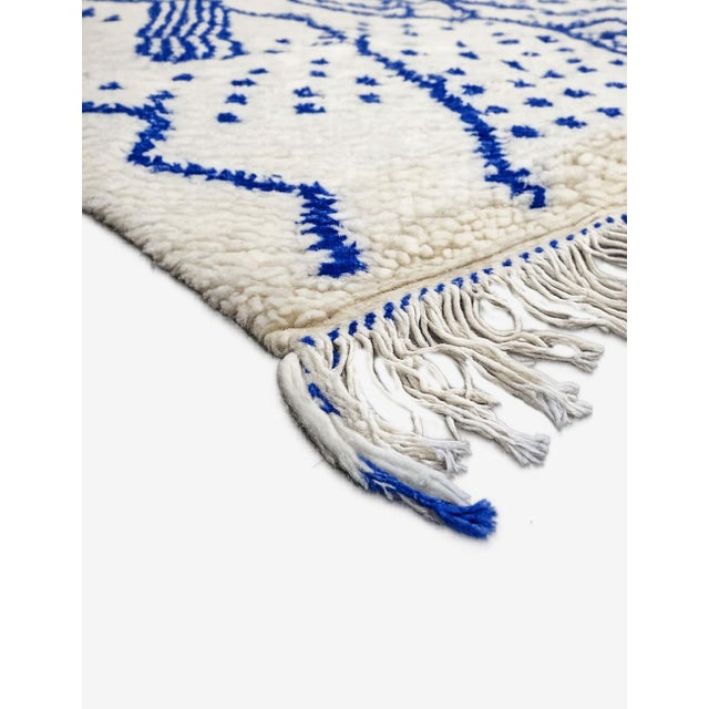 Blue & Ivory Azilal Rug – Handmade Moroccan Berber Wool Rug This handmade Azilal rug is a striking interpretation of...