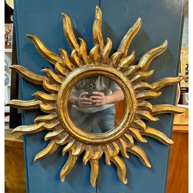 Vintage Italian cared and gilt-wood sunburst mirror. Italian sunburst mirrors are iconic decorative pieces, blending...