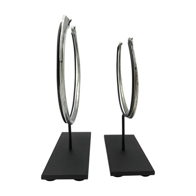 Elegant circular forms with fine etched designs at the base and bird-like tips. Sold as a set of 2. Known as a xauv, these...