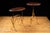 Matching pair of Maison Bagues-inspired occasional tables featuring brass-finished faux bamboo metal bases with dark-...