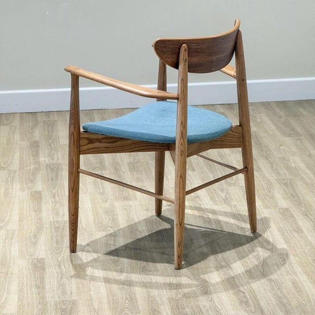 This mid-century modern armchair, handcrafted in Denmark , features a beautifully sculptural frame made from solid elm...