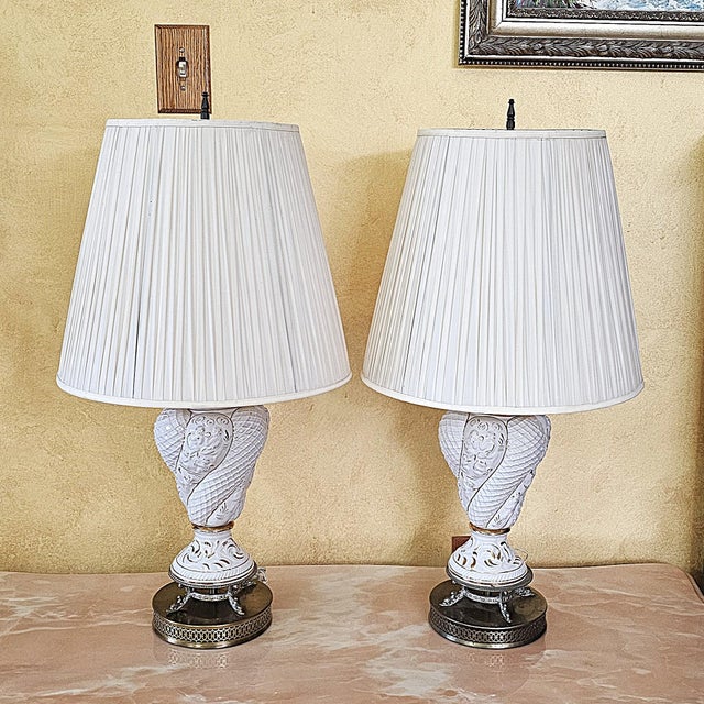 These Italian Capodimonte lamps bring together ornate sculpted ceramic, soft white and gold detailing, and a tall, elegant...