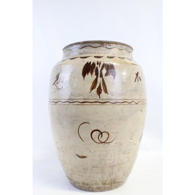 Our terracotta pot features neutral tones with a creamy tan base. Shows both gray & brown dimples, and streaks throughout....