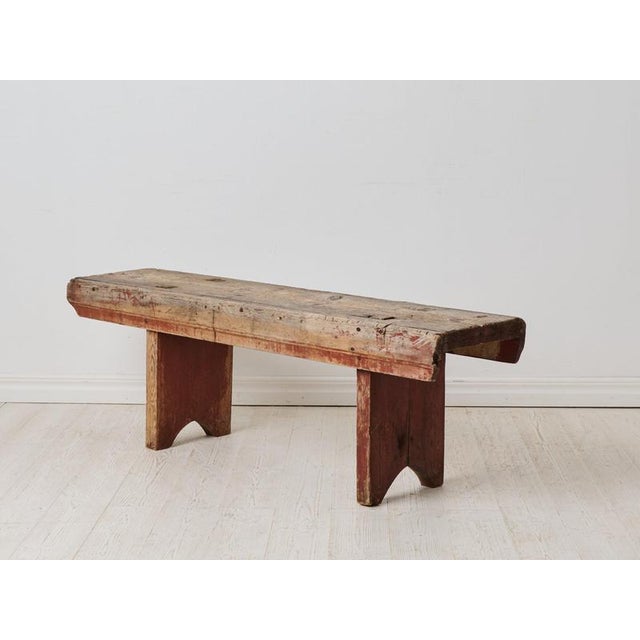 Rustic well-loved folk art bench from the late 1700s. This antique bench is from northern Sweden and made by hand in pine....