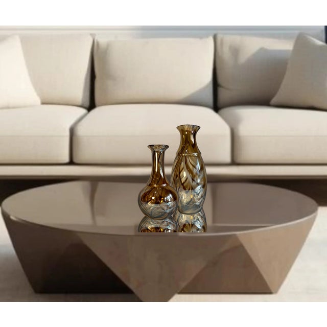 This cohesive two‑piece set brings together a pair of striking vintage art glass vases, each hand‑blown in the Italian...