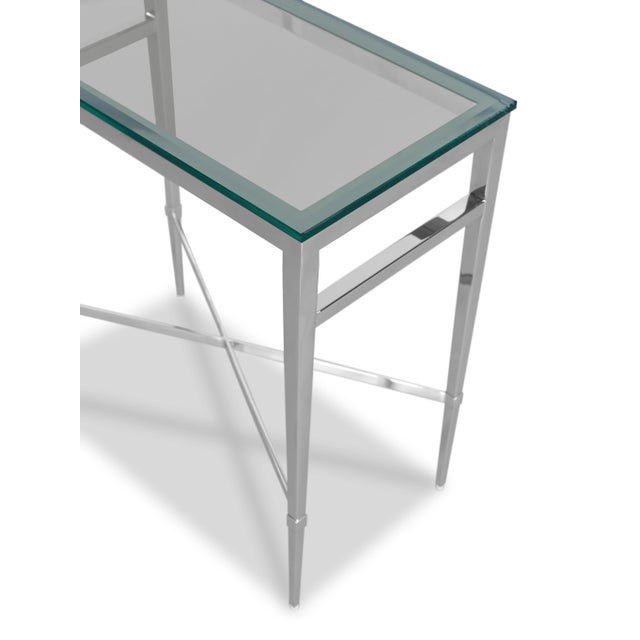 A terrific modern form crafted in metal and finished in a polished nickel. A rectangular beveled glass top rests over four...