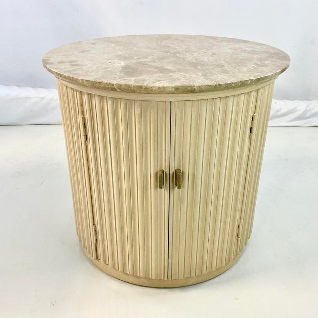 This is a gorgeous large round side table. It’s by Century Furniture and features a neutral travertine-like marble top....