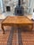 Walnut coffee table with fleur-de-lis patterns along the edges, beautiful wood and graceful design. Excellent condition,...